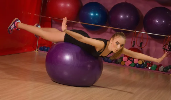 Fit woman exercising with a fit ball