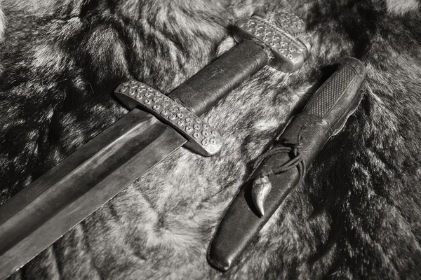 Viking sword and knife on a fur