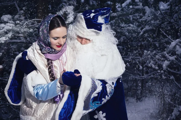 Morozko. Ded Moroz (Father Frost) and girl in the winter forest
