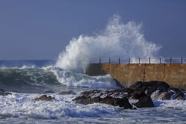 Wave splash near the pier of lighthouse, Porto, Portugal