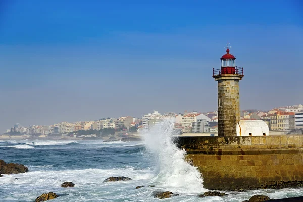 Lighthouse Felgueirasin Porto with waves and cityscape