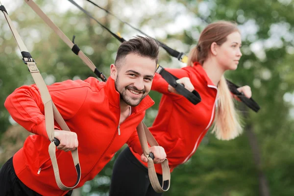 Sport man and woman training in park