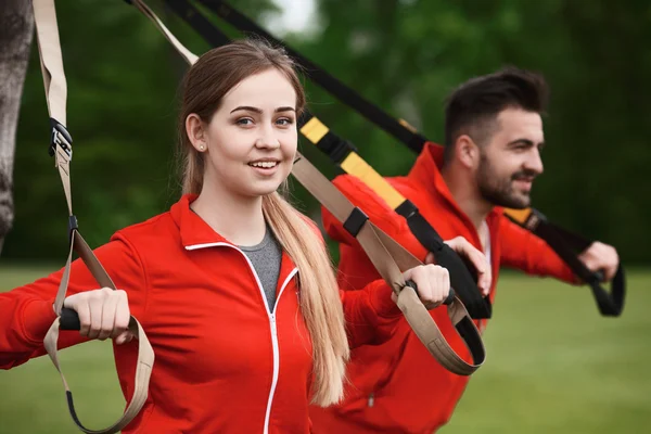 Sport man and woman training in park
