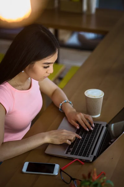 Freelance woman working in restaurant