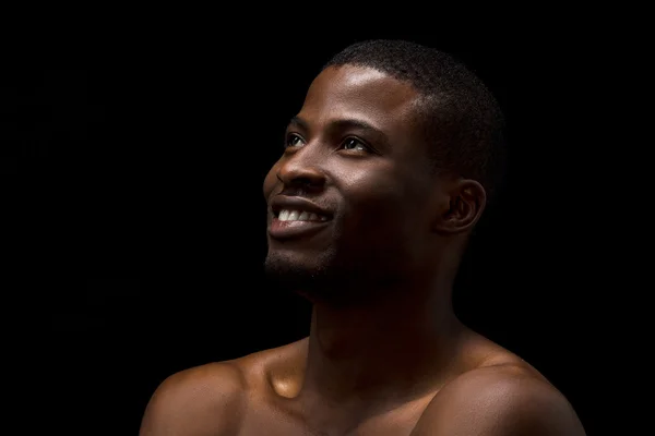 Naked black man posing in studio