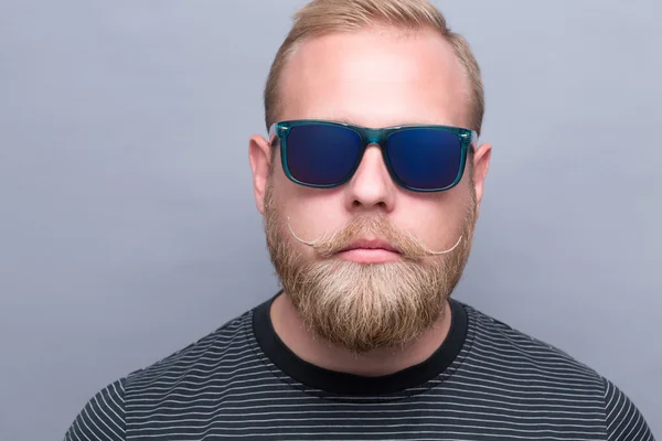Serious bearded man in sunglasses