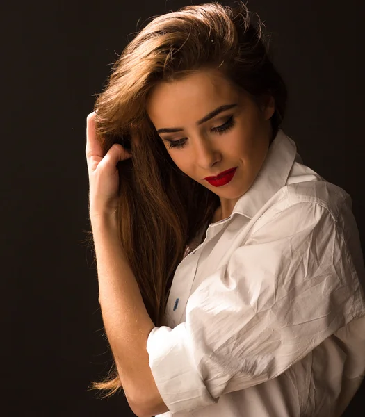 Beautiful lady in white shirt in studio