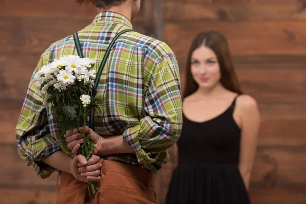 Man presenting his girl-friend beautiful flowers