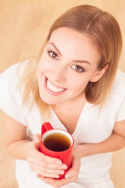 Lady with a cup of tea indoors