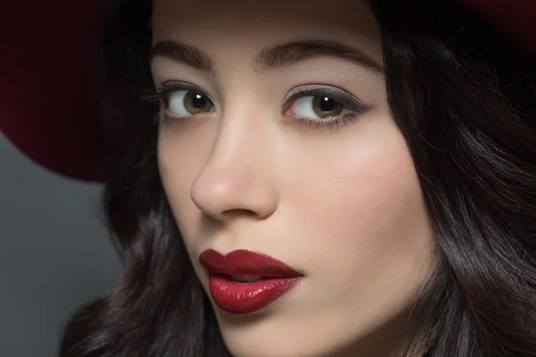 Fashion model woman with dark red hat on