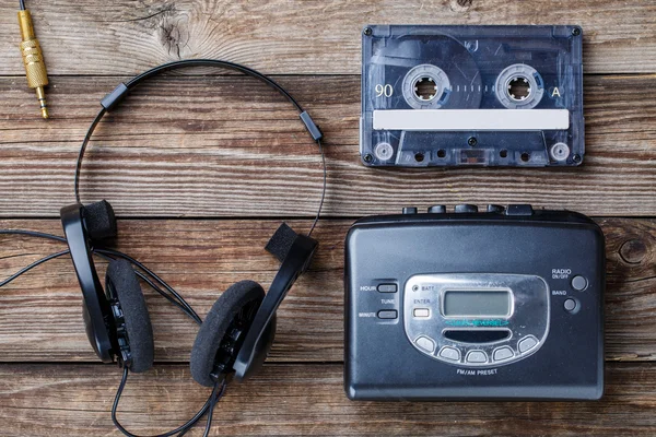 Music concept. Top view of cassette tape, audio player and headphones.