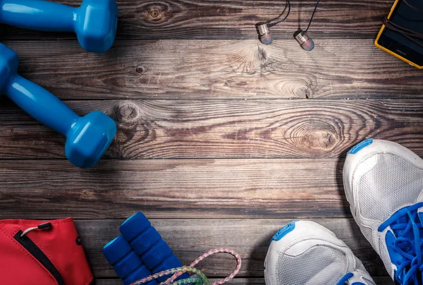 Sport stuff on wooden table, top view