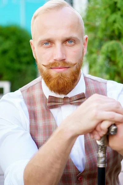 Portrait of stylish blonde man with red beard