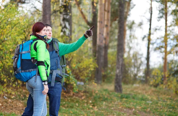 People hiking, man and woman looking around