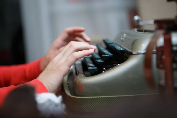 Hands of a man typing on typewriter