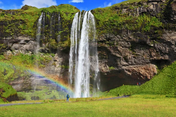 Large rainbow decorates a drop of water