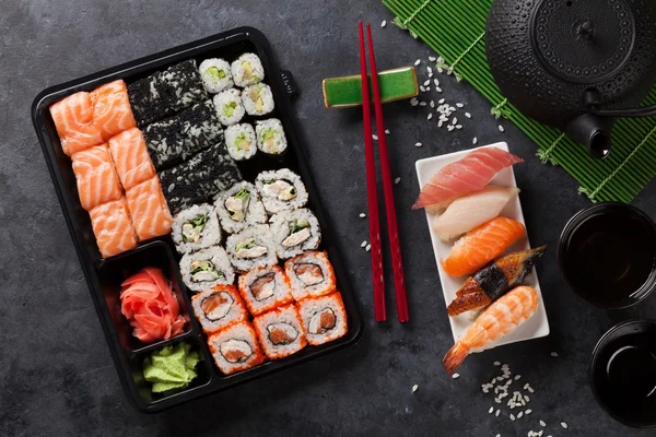 Sushi and maki rolls and green tea
