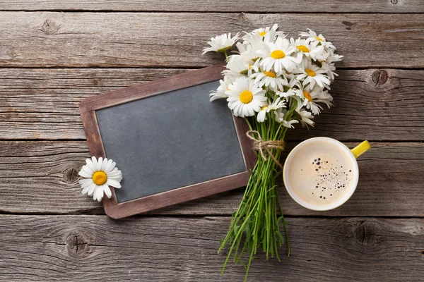 Blackboard with flowers and coffee cup