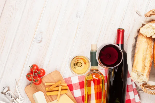 White and red wine on wooden table