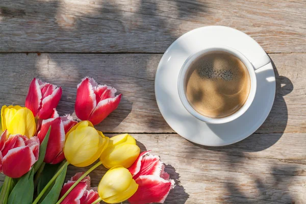Colorful tulips and coffee cup