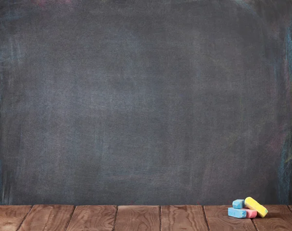 Colorful chalks on classroom table