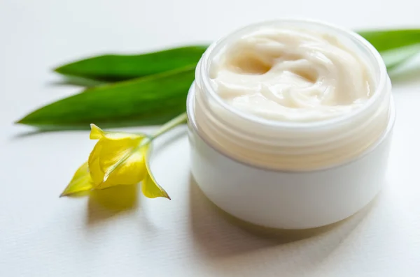 Jar of beauty cream with tulip