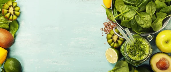 Healthy green smoothie and ingredients on blue background