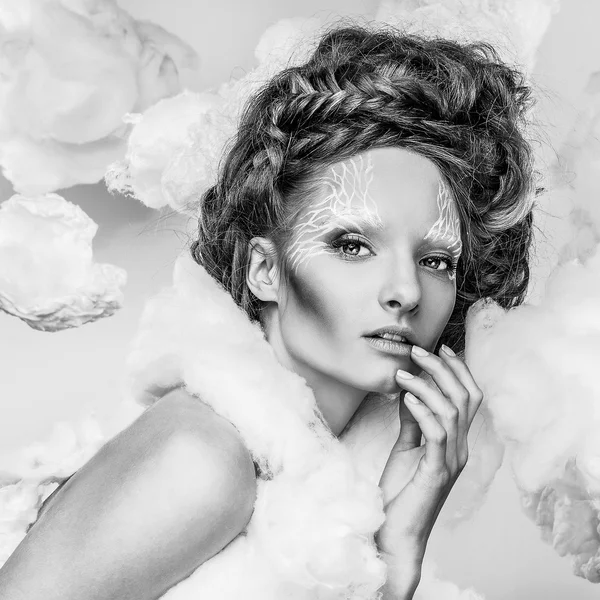 Romantic beauty with magnificent hair wandering in clouds. Fine art black-white studio fashion portrait.