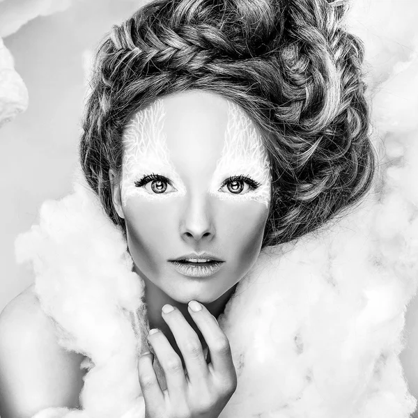 Romantic beauty with magnificent hair wandering in clouds. Fine art black-white studio fashion portrait.