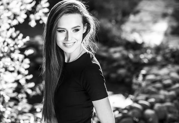 Outdoors black-white portrait of beautiful young long hair brunette woman