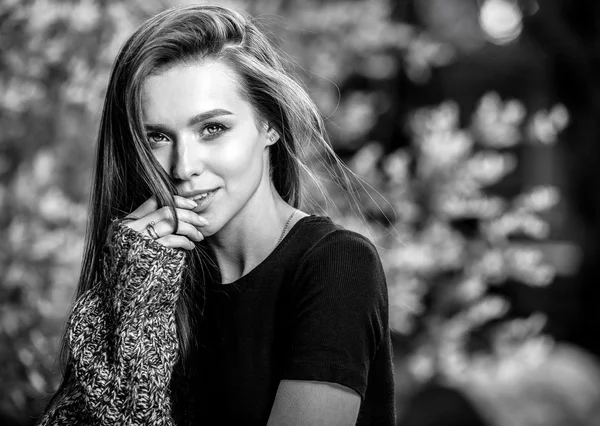 Outdoors black-white portrait of beautiful young long hair brunette woman