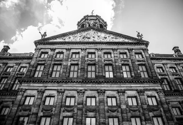 AMSTERDAM, NETHERLANDS - AUGUST 6, 2016: Famous buildings of Amsterdam city centre close-up. General landscape view of city streets and traditional Dutch architecture. Amsterdam - Netherlands.