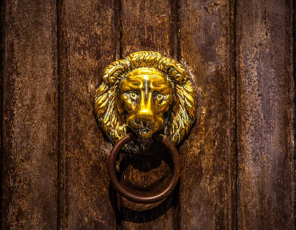 Ancient Venetian door with old door knob close-up.