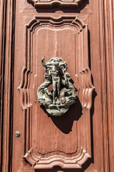 Ancient Venetian door with old door knob close-up.