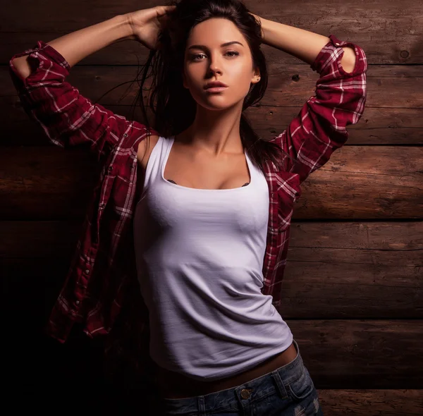 Young sensual & beauty woman in casual clothes pose on grunge wooden background.
