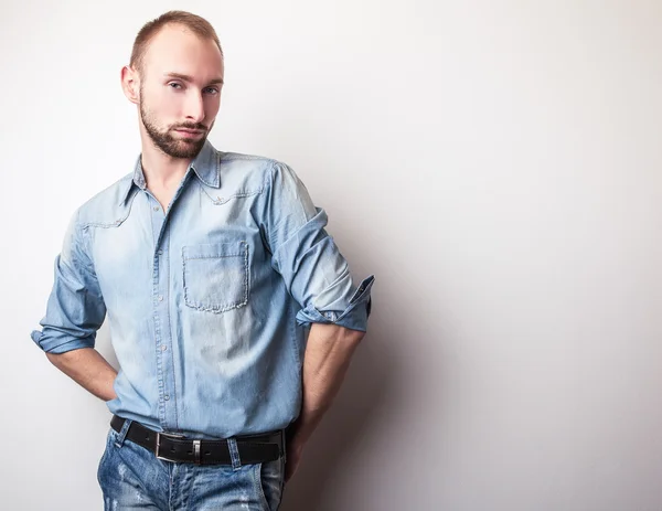 Young handsome man in jeans clothes. Studio fashion portrait.