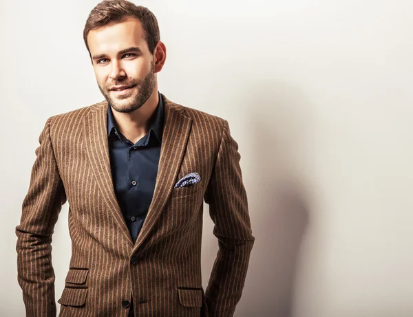 Elegant young handsome man in luxury costume. Studio fashion portrait.