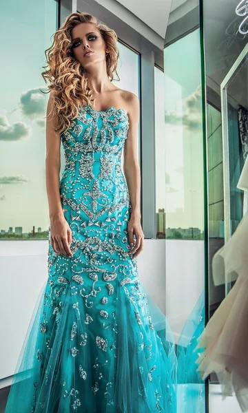 Elegant young woman in luxury dress