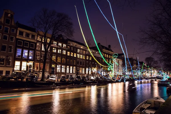 Cruise boat with blur light moving on night canals of Amsterdam.