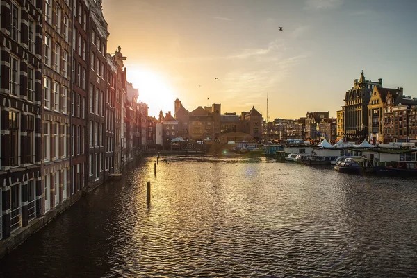 AMSTERDAM, NETHERLANDS - JANUARY 30, 2015: Beautiful views of streets, ancient buildings, boat, embankments of Amsterdam - also call \