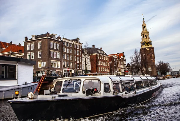 AMSTERDAM, NETHERLANDS - JANUARY 30, 2015: Beautiful views of streets, ancient buildings, boat, embankments of Amsterdam - also call 