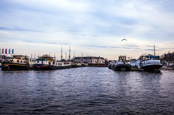 AMSTERDAM, NETHERLANDS - JANUARY 30, 2015: Beautiful views of streets, ancient buildings, boat, embankments of Amsterdam - also call \