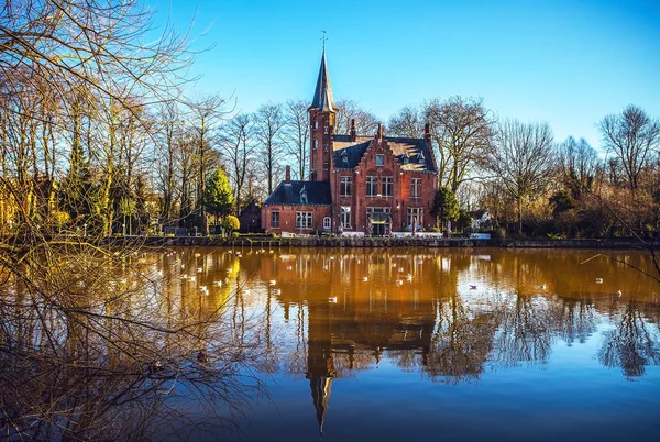 Medieval building (Castle) on Love lake, Minnewater Park in Bruges, Belgium