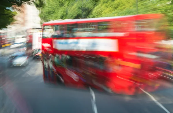 Fast moving red bus in London