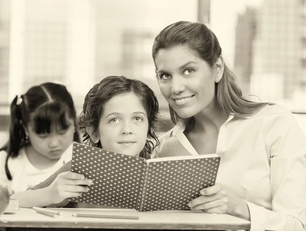 Beautiful teacher with mixed race classroom