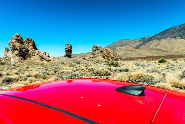 Red car roof with mountain scenario