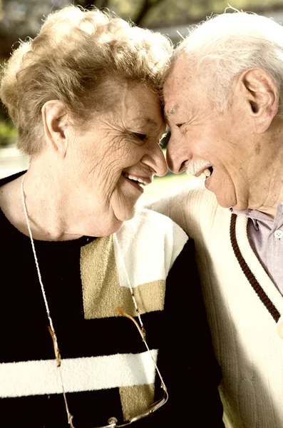 Happy elder couple face to face smiling. Retirement and love con