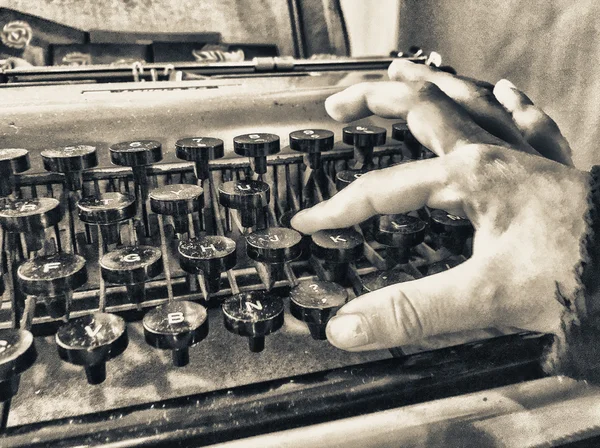 Baby hand typing on  old typewriter