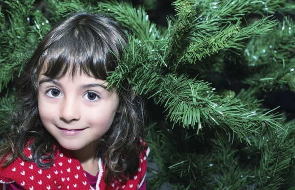 Girl enjoying Christmas tree at home