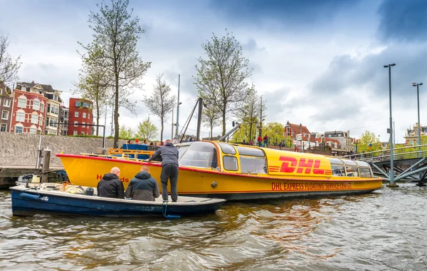 AMSTERDAM, APRIL 15, 2015: DHL post company boat delivering mail